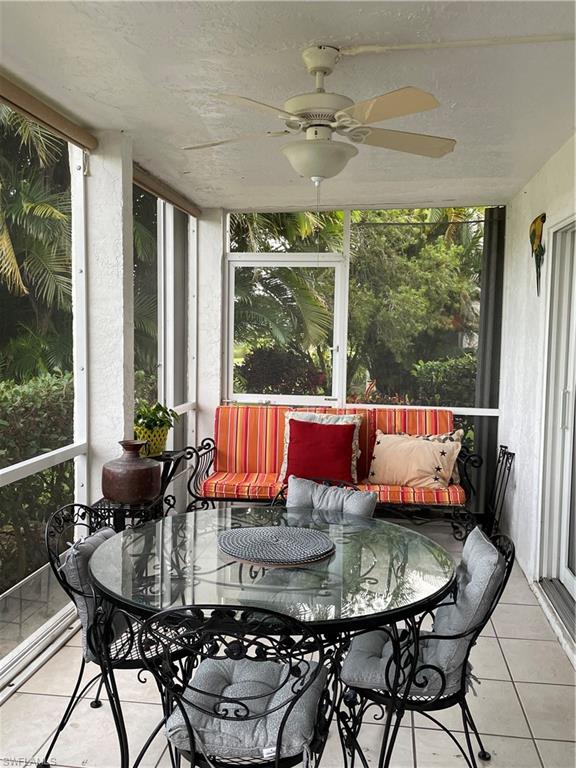 541 Teryl Road, Unit 1 Naples, FL 34112 - Photo 11 of 33 a view of a dining room with furniture large windows and wooden floor