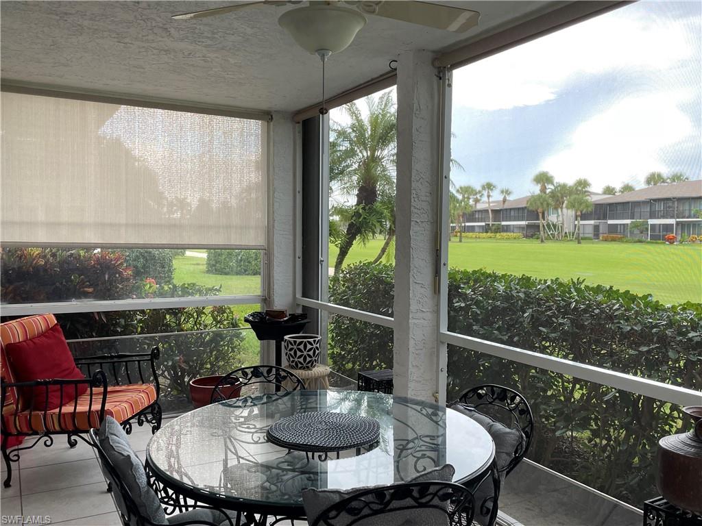 541 Teryl Road, Unit 1 Naples, FL 34112 - Photo 13 of 33 a view of a porch with furniture and a yard