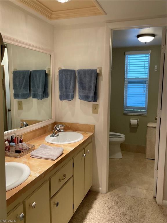 541 Teryl Road, Unit 1 Naples, FL 34112 - Photo 17 of 33 a bathroom with a sink and a mirror