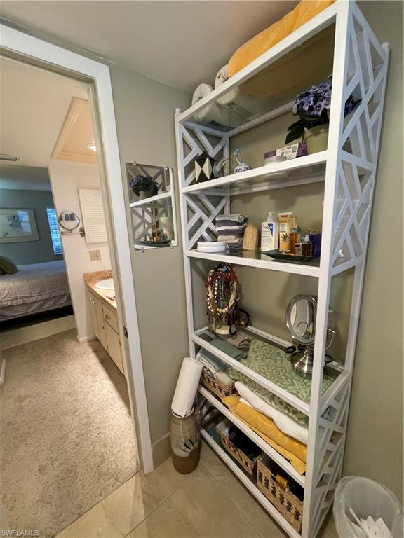541 Teryl Road, Unit 1 Naples, FL 34112 - Photo 20 of 33 a view of walk in closet with clothes and shoes