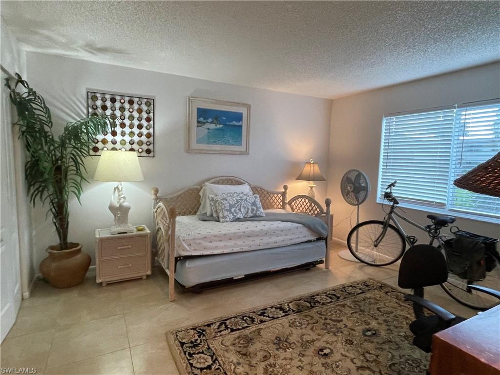 541 Teryl Road, Unit 1 Naples, FL 34112 - Photo 26 of 33 a living room with furniture a table and a potted plant