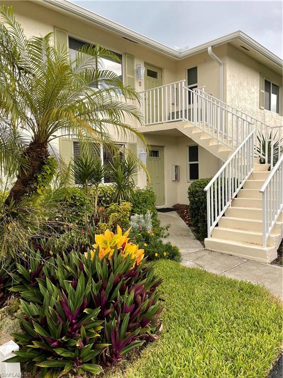 541 Teryl Road, Unit 1 Naples, FL 34112 - Photo 3 of 33 a view of a house with a flower garden