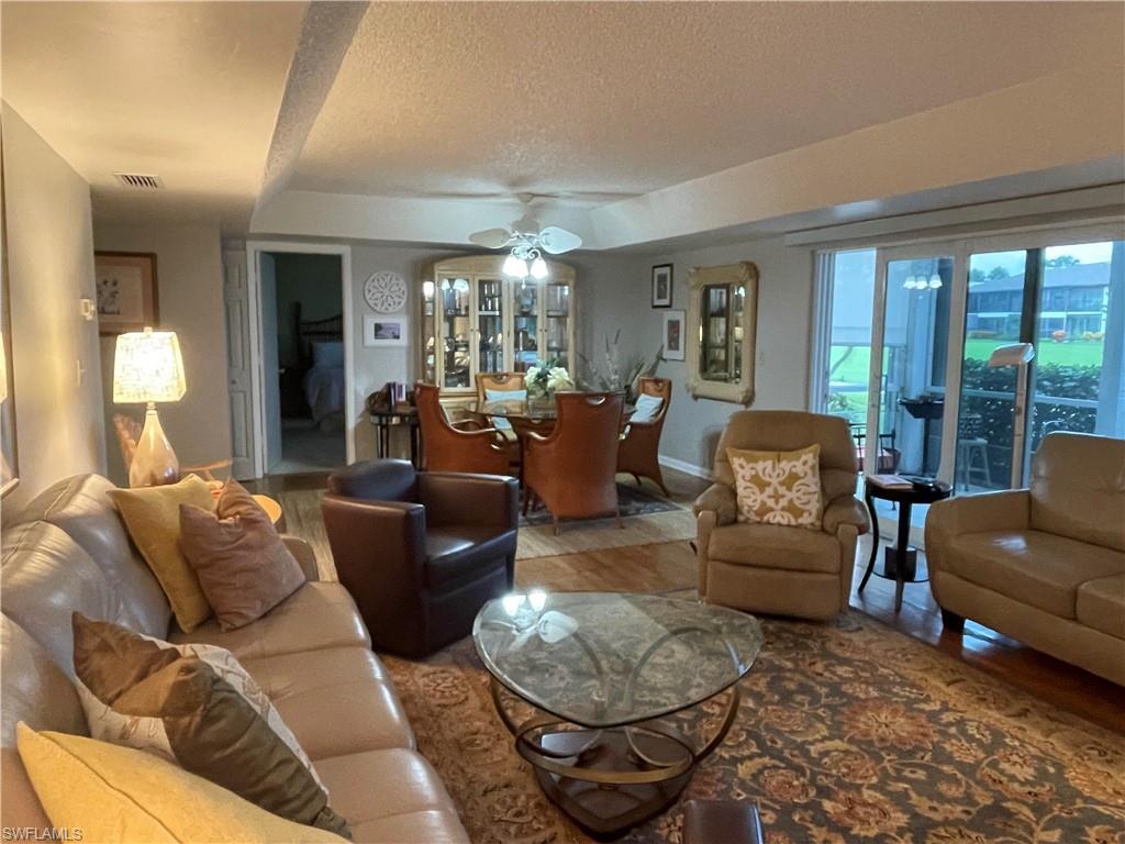 541 Teryl Road, Unit 1 Naples, FL 34112 - Photo 8 of 33 a living room with furniture and a large window