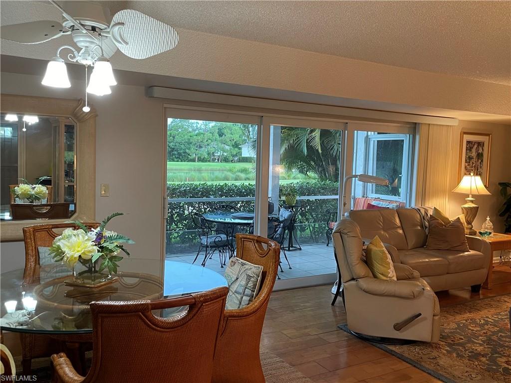 541 Teryl Road, Unit 1 Naples, FL 34112 - Photo 9 of 33 a living room with patio furniture and a large window