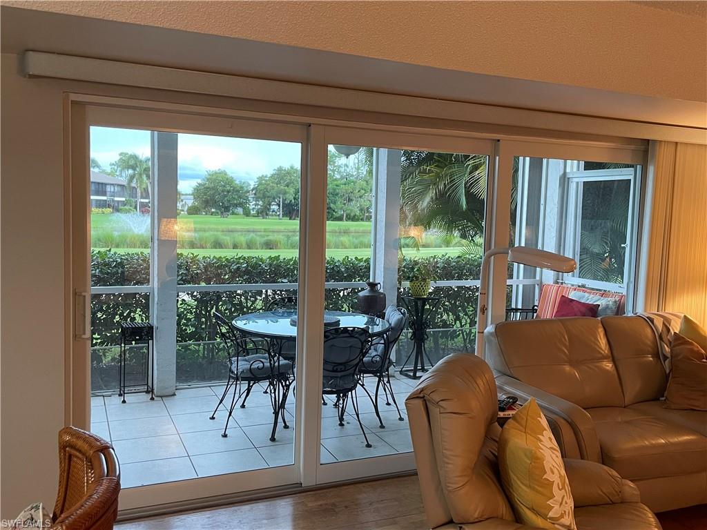 541 Teryl Road, Unit 1 Naples, FL 34112 - Photo 10 of 33 a living room with furniture and a large window