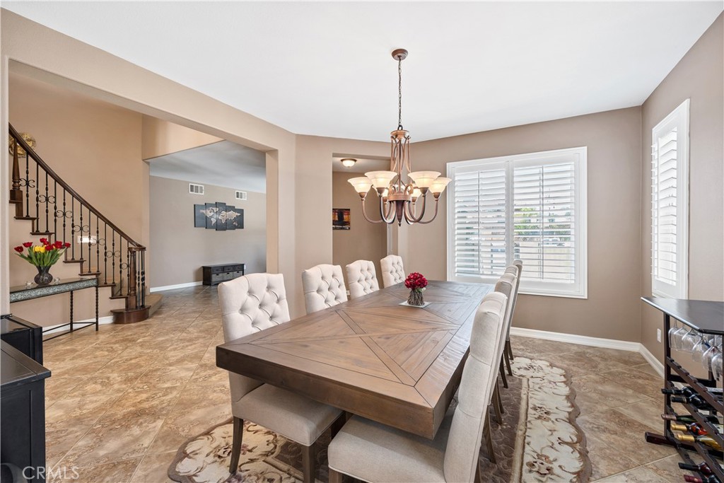 353 Caldera Street Perris, CA 92570 - Photo 12 of 53 a view of a dining room with furniture window and wooden floor