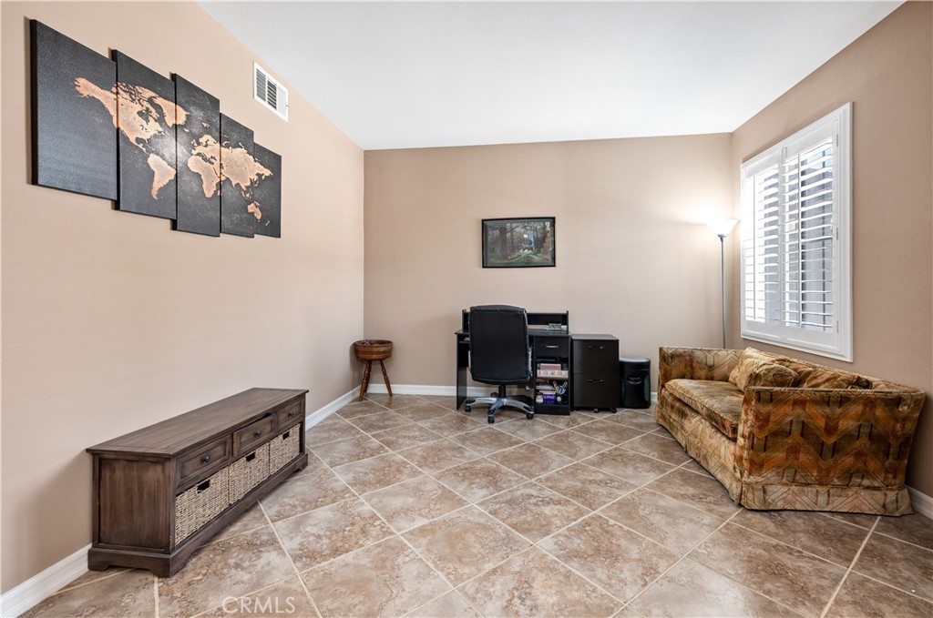 353 Caldera Street Perris, CA 92570 - Photo 16 of 53 a living room with furniture and a flat screen tv