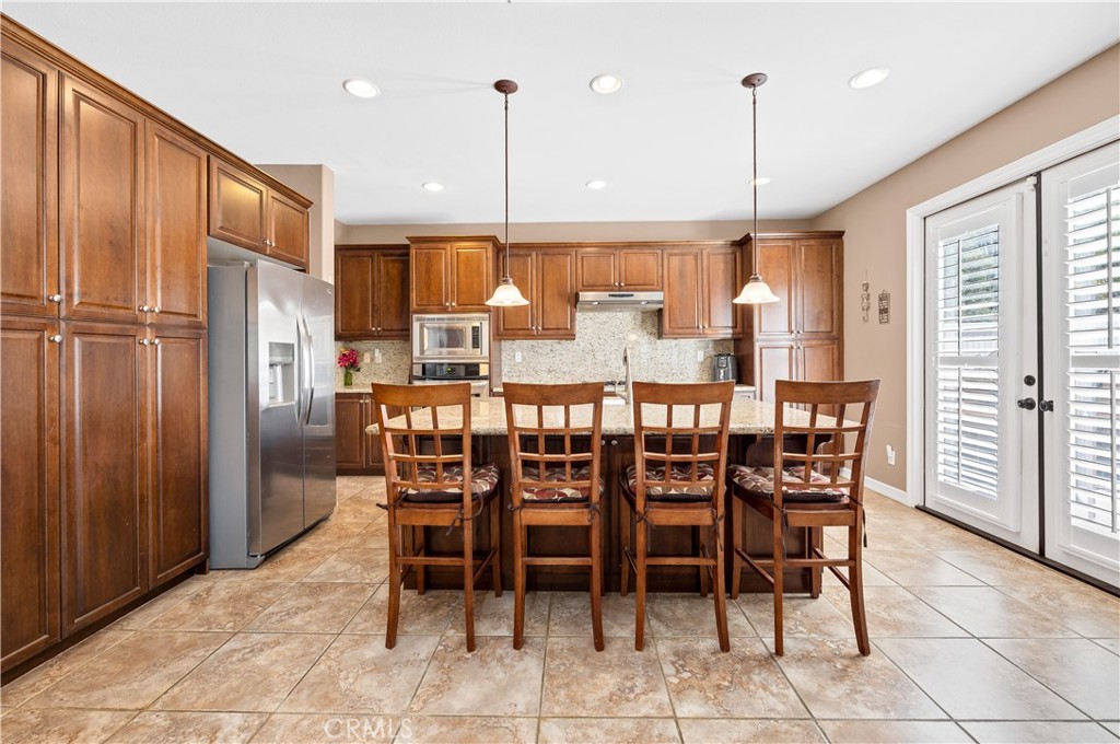 353 Caldera Street Perris, CA 92570 - Photo 17 of 53 a dining table with a large window and chairs
