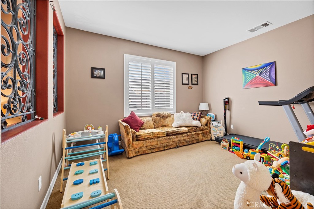 353 Caldera Street Perris, CA 92570 - Photo 28 of 53 a bedroom with furniture and a window