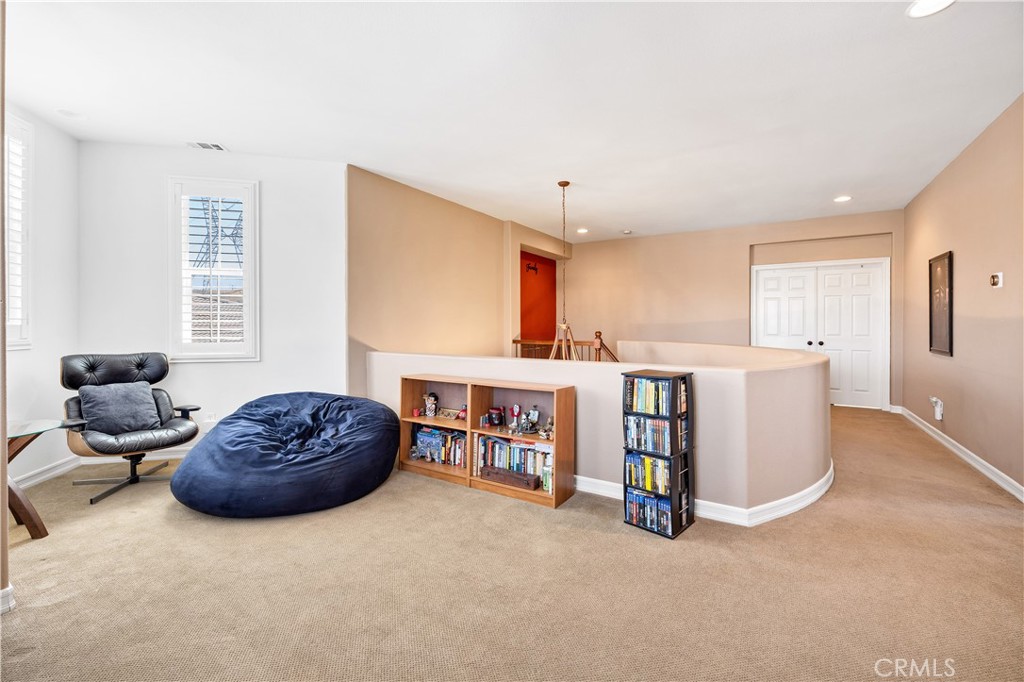 353 Caldera Street Perris, CA 92570 - Photo 33 of 53 a living room with a couch and a dresser with windows