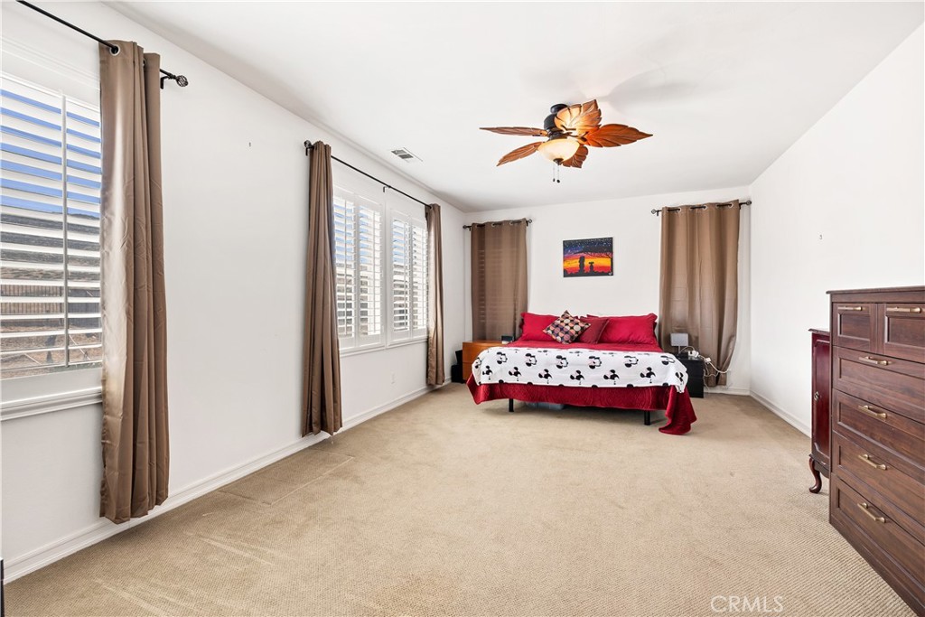 353 Caldera Street Perris, CA 92570 - Photo 35 of 53 a bedroom with a bed and a chandelier