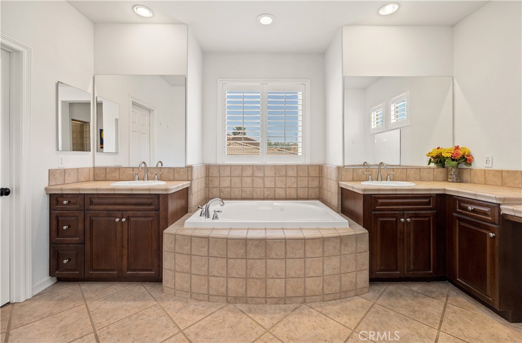 353 Caldera Street Perris, CA 92570 - Photo 37 of 53 a spacious bathroom with a tub sink and mirror