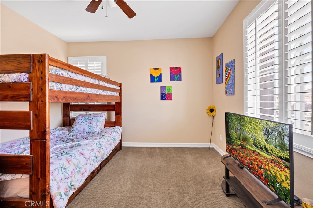 353 Caldera Street Perris, CA 92570 - Photo 39 of 53 a bedroom with furniture and a flat screen tv