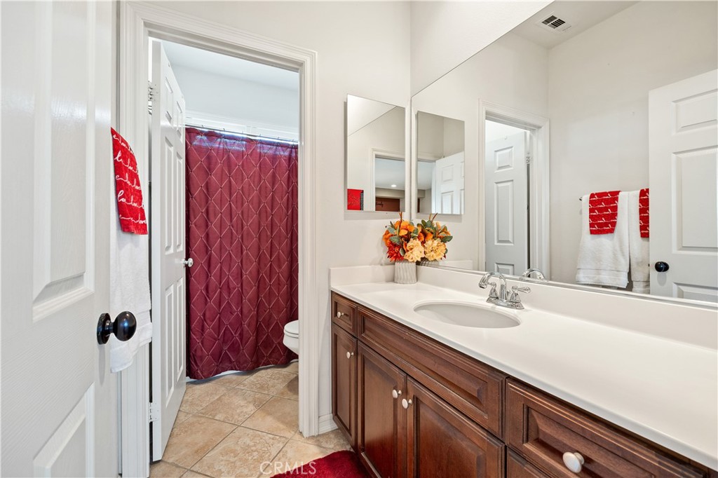 353 Caldera Street Perris, CA 92570 - Photo 41 of 53 a bathroom with a sink vanity and a mirror