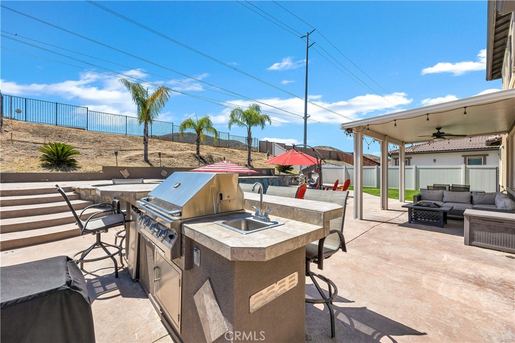 353 Caldera Street Perris, CA 92570 - Photo 42 of 53 a view of a dinning table and chairs in the patio