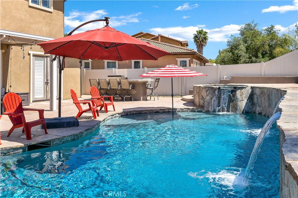 353 Caldera Street Perris, CA 92570 - Photo 45 of 53 a view of a patio with a table and chairs under an umbrella