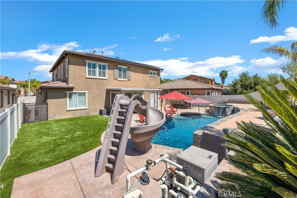 353 Caldera Street Perris, CA 92570 - Photo 47 of 53 a view of a patio with table and chairs with wooden floor and fence