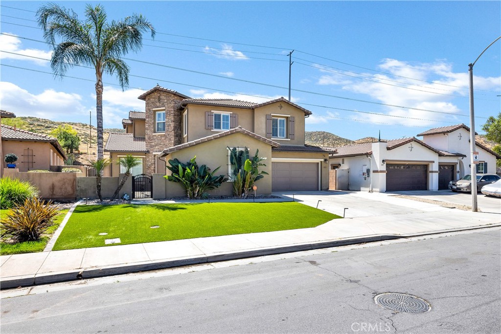 353 Caldera Street Perris, CA 92570 - Photo 5 of 53 a front view of a house with a yard and palm trees