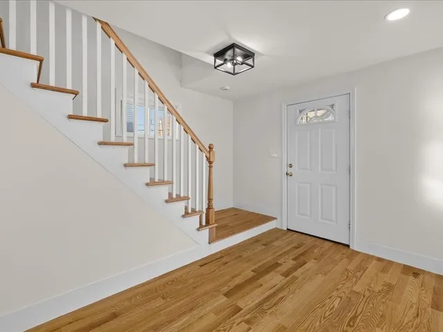 a view of an entryway with wooden floor