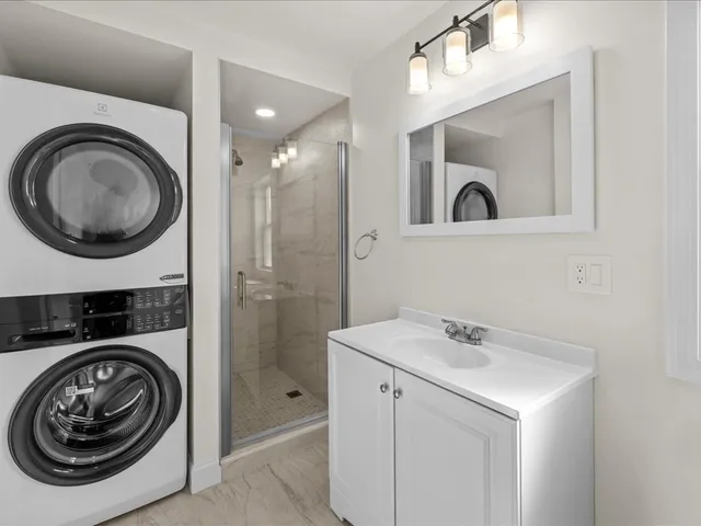 a utility room with sink dryer and washer
