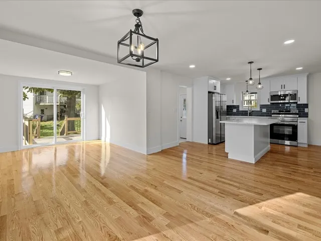 a view of a kitchen with a stove wooden floor and a kitchen view
