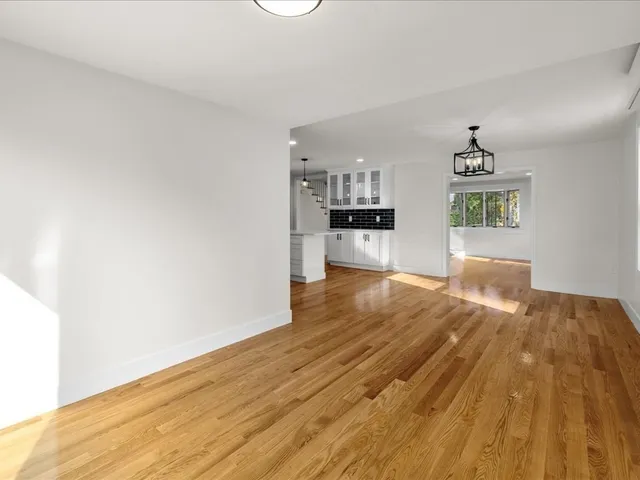 a view of a kitchen with wooden floor and a sink