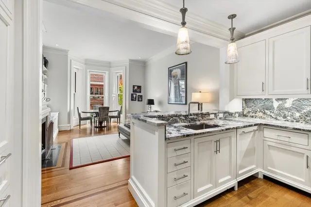 a kitchen with granite countertop a sink and a stove top oven