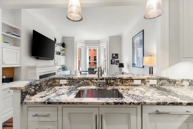 a kitchen with white cabinets and appliances