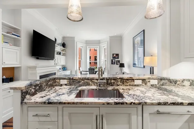 a kitchen with white cabinets and appliances