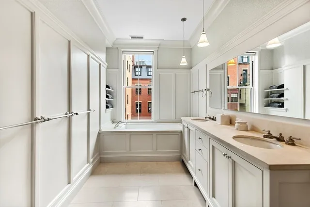 a view of a bedroom with cabinet mirror and window