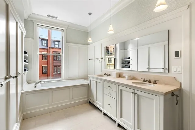 a bathroom with a granite countertop sink mirror and a bathtub
