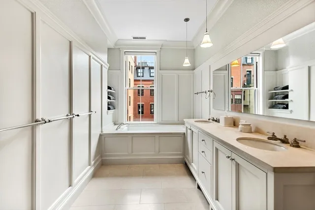 a view of a bedroom with cabinet mirror and window
