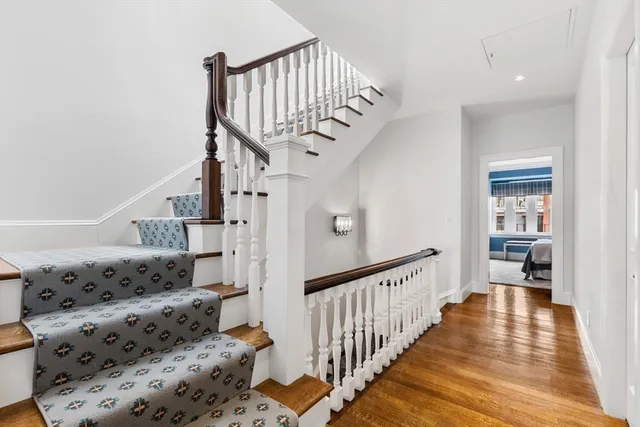 a view of a rooftop deck with chairs and city view