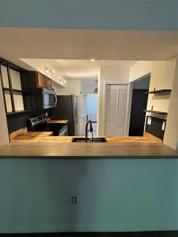 a view of kitchen sink and wooden floor