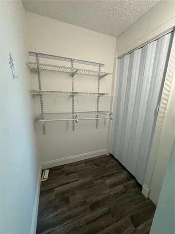 a view of a room with wooden floor