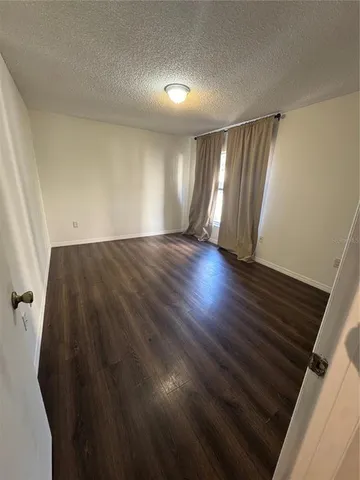 a view of an empty room and wooden floor