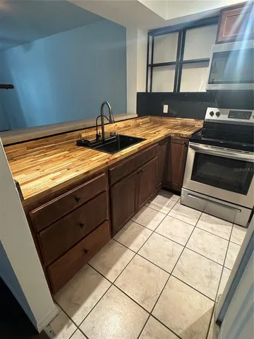 a kitchen with a sink stove and cabinets