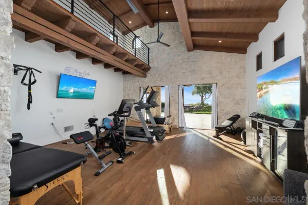 a spacious bedroom with a bed and a large window