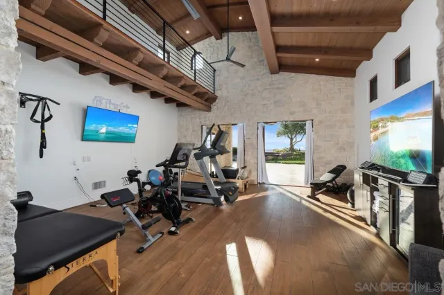 a spacious bedroom with a bed and a large window