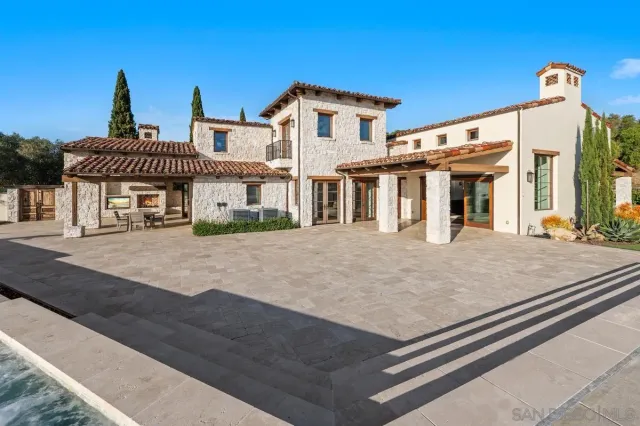 a view of a balcony with chairs and wooden floor