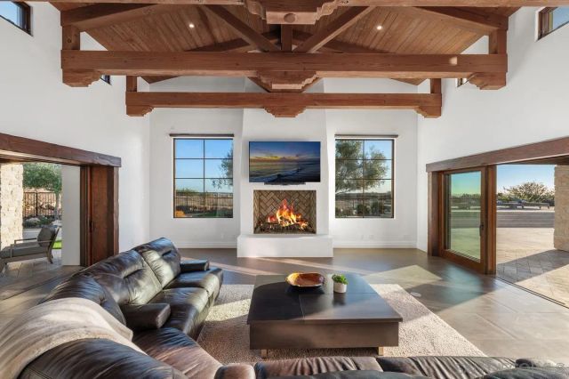 a living room with furniture and a floor to ceiling window