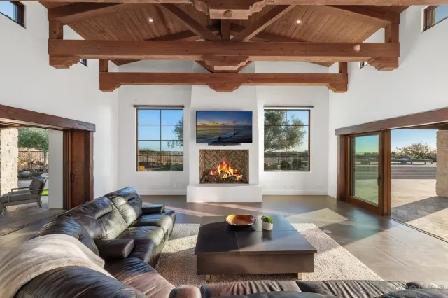 a living room with furniture and a floor to ceiling window
