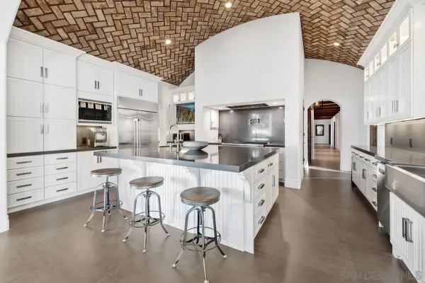 a kitchen with stainless steel appliances granite countertop a sink and a stove