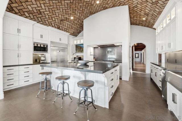 a kitchen with stainless steel appliances granite countertop a sink and a stove