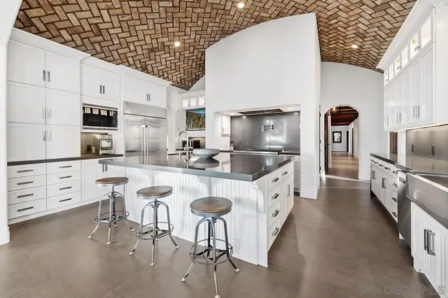 a kitchen with stainless steel appliances granite countertop a sink and a stove