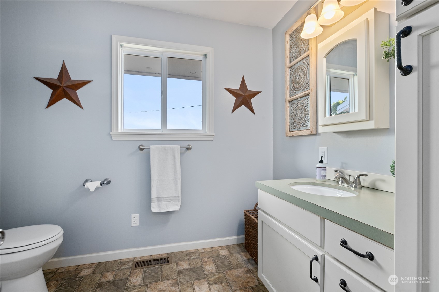 9699 Double Ditch Road Lynden, WA 98264 - Photo 14 of 40 a bathroom with a granite countertop sink a toilet and a mirror