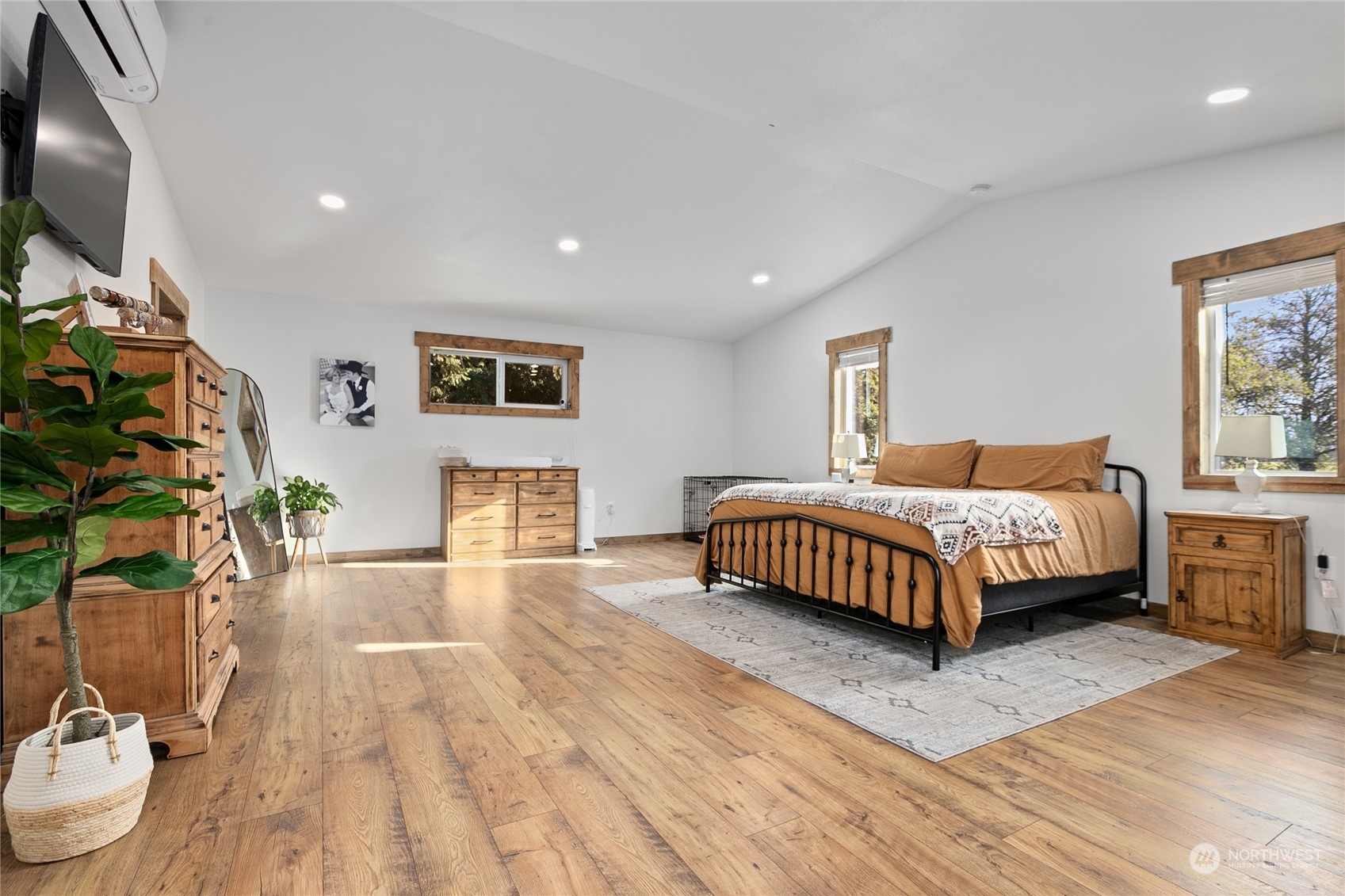 9699 Double Ditch Road Lynden, WA 98264 - Photo 16 of 40 a bedroom with a bed table flowerpot and a potted plant
