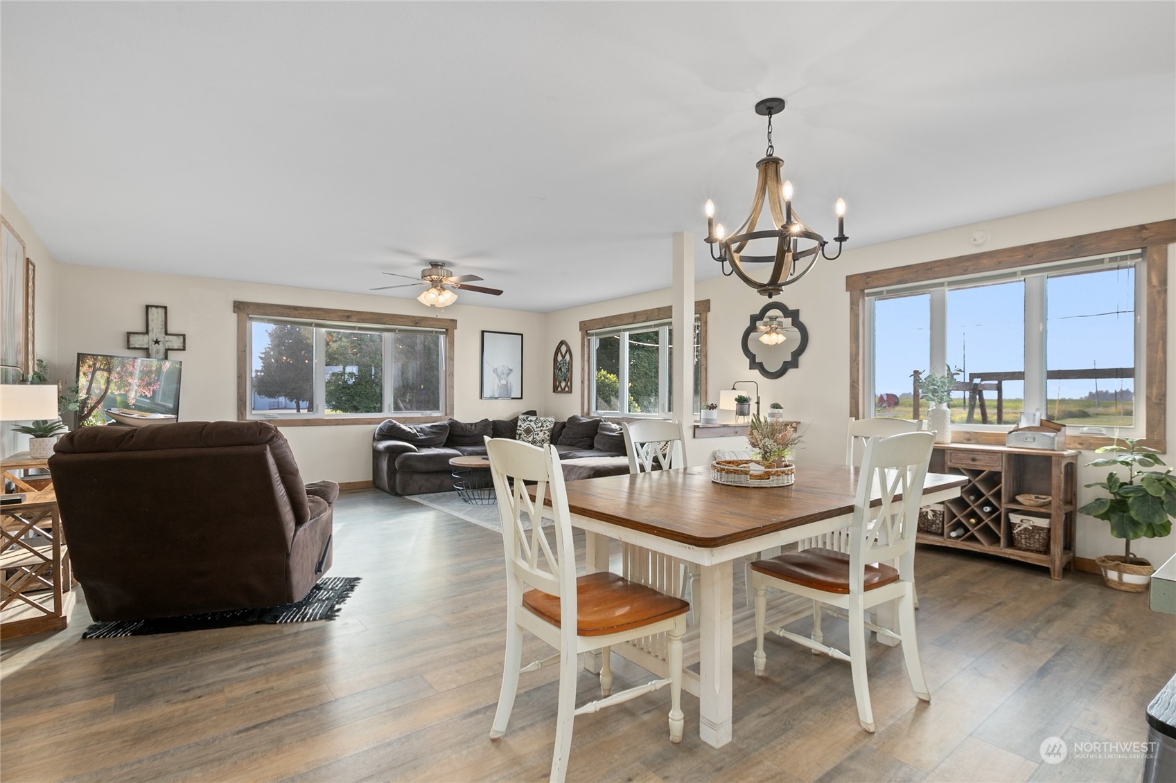 9699 Double Ditch Road Lynden, WA 98264 - Photo 8 of 40 a dining room with wooden floor a chandelier a wooden table and chairs
