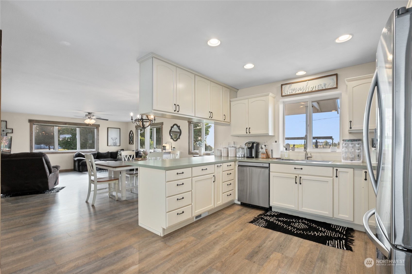 9699 Double Ditch Road Lynden, WA 98264 - Photo 9 of 40 a kitchen with sink refrigerator and cabinets