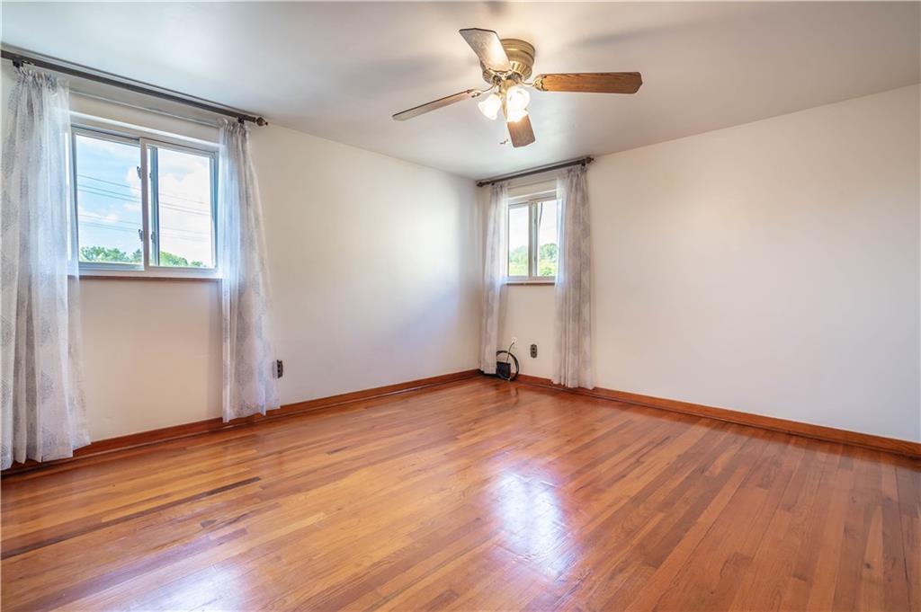 1465 Prospect Road Pittsburgh, PA 15227 - Photo 11 of 25 MASTER BEDROOM WITH HARDWOOD FLOORS, CEILING FAN AND 2 WINDOWS MAKING IT VERY BRIGHT